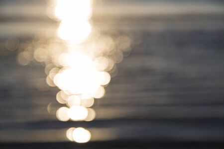 blurred ocean background with reflections and bokeh