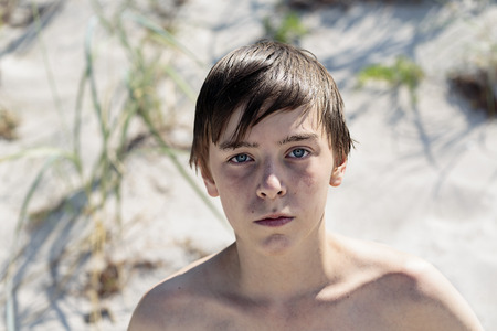 portrait of a beautiful teenage boy at the beachの写真素材