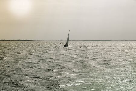 sailing boat at the ocean in the eveningの写真素材