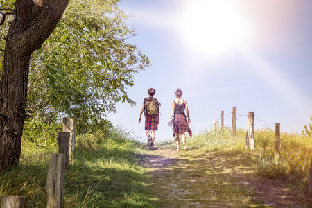two teenager walking a path at noonの写真素材