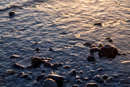 wet pebbles at the sunset for backgrounds