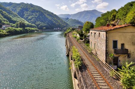railroad along the river Serchio and Apuan Alps, Tuscany, Italyの写真素材