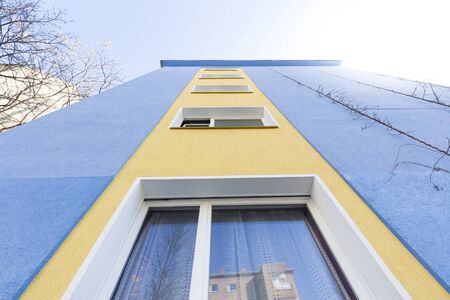 blue and yellow facade of an apartment houseの写真素材