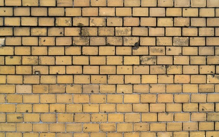 simple yellow brick wall for backgroundsの写真素材