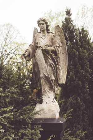 old sculpture of an angel in nature. Unknown artist of the 19th.の写真素材