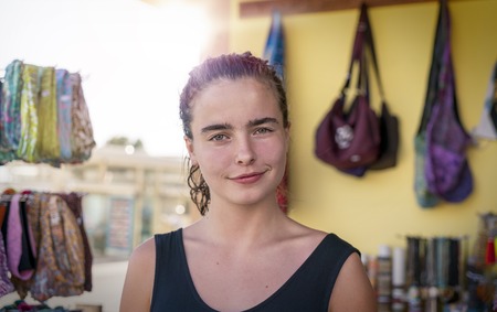 portrait of a smiling young woman in a shopの写真素材