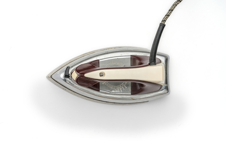 very old steam iron from the fifties, isolated on whiteの写真素材
