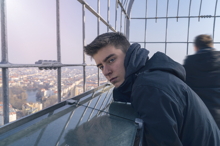 portrait of a young man on an observation towerの写真素材