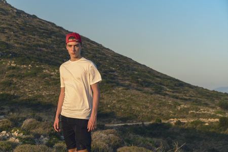 mediterranean mountain landscape with portrait of a young manの写真素材