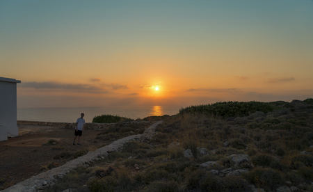 sunset over the sea and walking young manの写真素材
