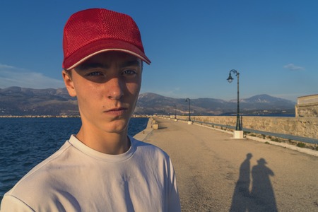 young man on vacation with the shadow of the photographerの写真素材