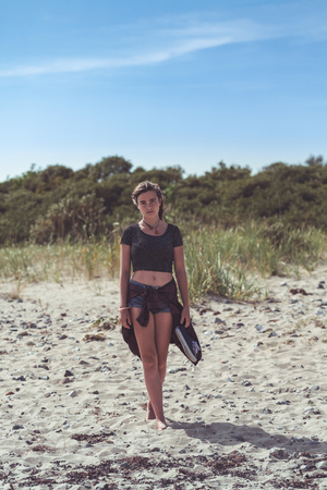 portrait of a young woman standing on the beachの写真素材