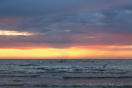 sunset over the baltic sea with cloudscapeの写真素材