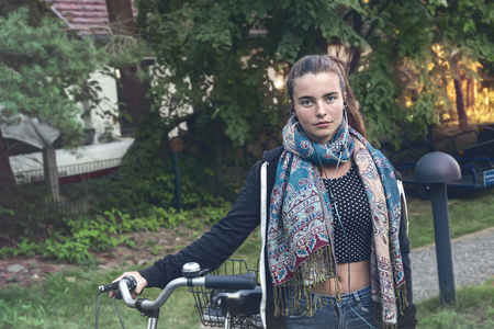 portrait of a young woman with bicycleの写真素材