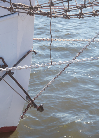 closeup of the prow of a big sailing yacht, with chains and anchorの写真素材