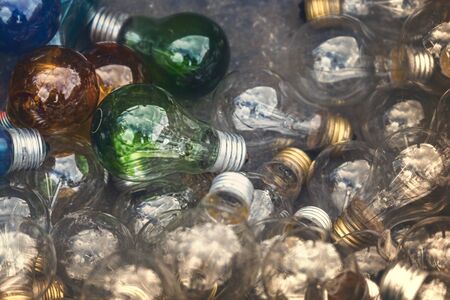 colored light bulbs laying on the ground