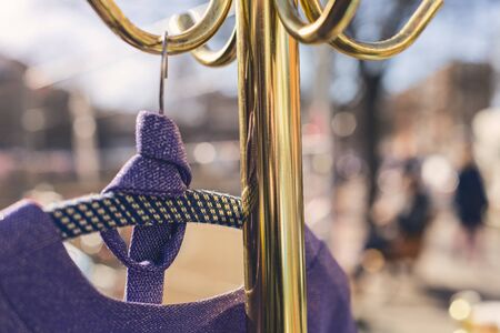 flea market, purple dress hanging on a golden clothes rackの写真素材