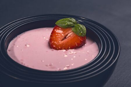 strawberry yogurt in black asian bowlsの写真素材
