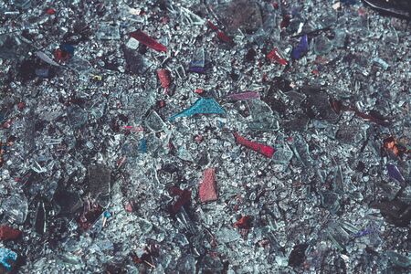 close up of colorful glass shards covering the groundの写真素材