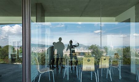 Barcelona mirroring in a window with three personsの写真素材