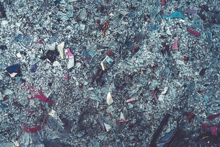 close up of colorful glass shards covering the groundの写真素材