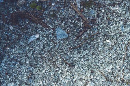 close up of colorful glass shards covering the groundの写真素材