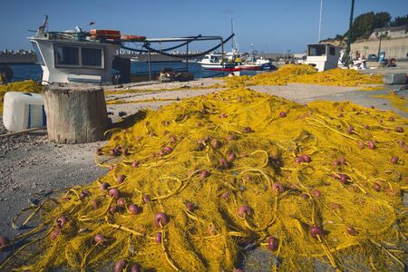 yellow fishnet laying on a pier in front of the hookerの写真素材