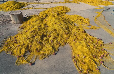 close up of a yellow fishnet with red floatsの写真素材