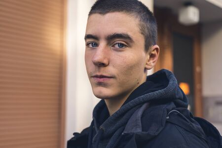 portrait of a candid young man in front of a houseの写真素材