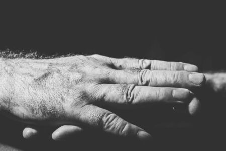 close-up of two hands lying relaxed on top of each otherの写真素材
