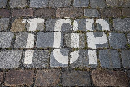 the word top with white color on cobblestone for backgrounds