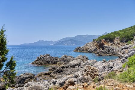 landscape with rocky coast near the city of ammoundia, greeceの写真素材