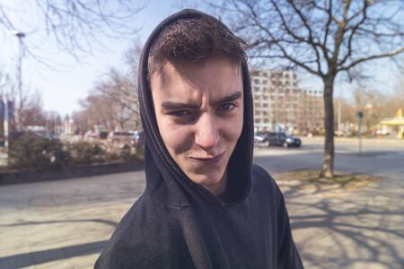 portrait of a lucky young man with hoodieの写真素材