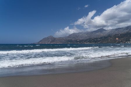 bay on crete with mountain range, beach and seaの写真素材