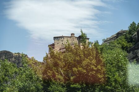 monastery in meteora photographed through a car window