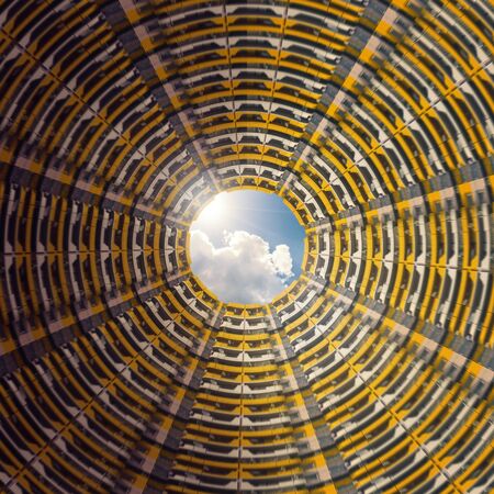 Composition, round courtyard of a high-rise building with yellow balconiesの写真素材