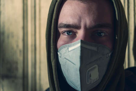 portrait of a young man with a FFP3 face maskの写真素材