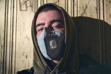 portrait of a young man with a FFP3 face maskの写真素材