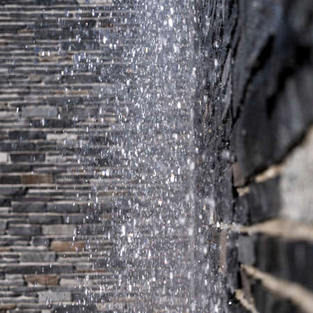 blurred water drops of a fountain for backgroundsの写真素材