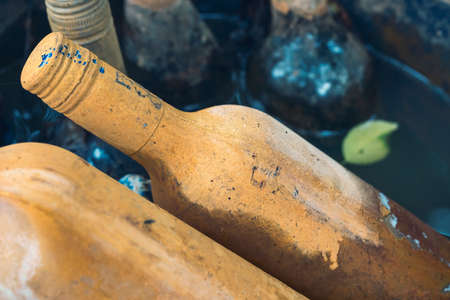 old wine bottles with limescale in a fountainの写真素材