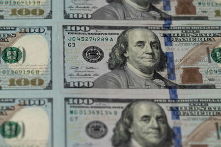 One hundred dollars. Benjamin Franklin. US dollars background. Closeup of a lot of banknotes hundred dollar bills. American currency.の写真素材
