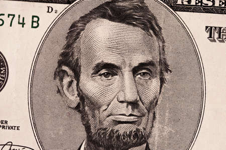 five dollar bills. Closeup of Abraham Lincoln . US dollars background. American currency.の写真素材