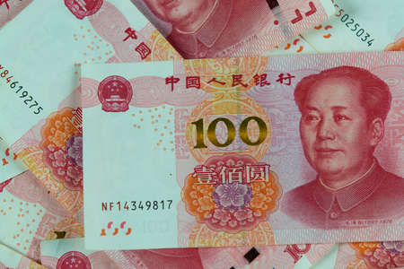 One hundred Chinese renminbi RMB bills. CNY background. Closeup of Mao Zedong . Macro. Chinese currency.の写真素材