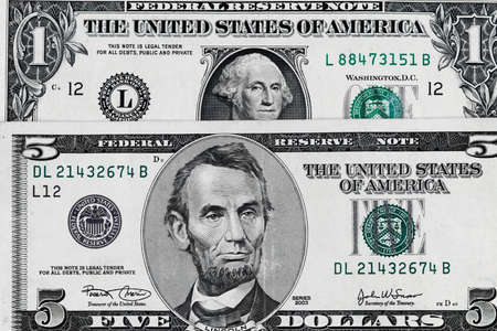 Five dollars and one dollar bills. Closeup of George Washington and Abraham Lincoln . US dollars background. American currency.の写真素材
