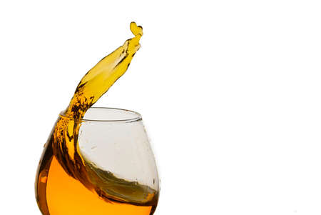 Freeze Action Photography .Splash of Cognac In glass Isolated on White.の写真素材