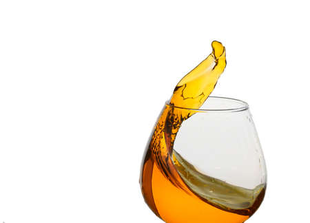 Freeze Action Photography .Splash of Cognac In glass Isolated on White.の写真素材