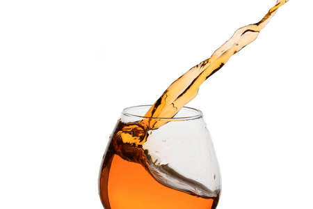 Freeze Action Photography .Splash of Cognac In glass Isolated on White.の写真素材