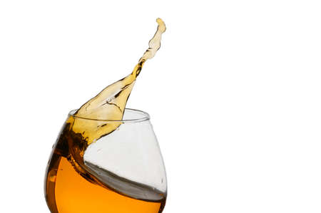Freeze Action Photography .Splash of Cognac In glass Isolated on White.の写真素材