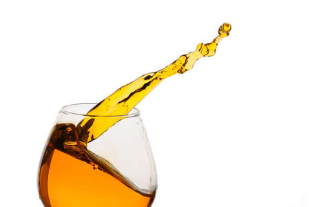 Freeze Action Photography .Splash of Cognac In glass Isolated on White.の写真素材