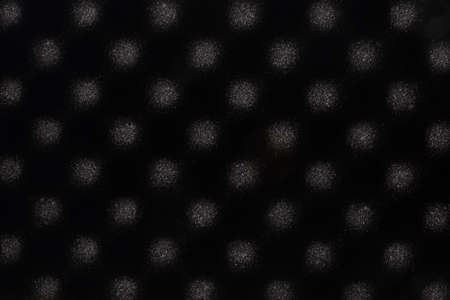 Black sponge abstract background with round soft light patterns. Sound absorbing spongeの写真素材